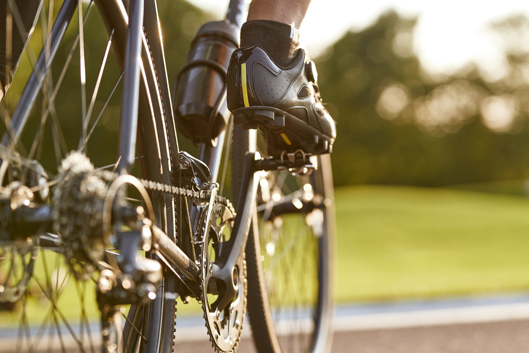 Cropped shot of a man cycling outdoors, focus on male legs